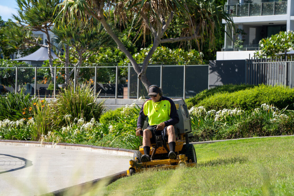 Advance Landscapes team member ride-on mowing at Allisee Residential Apartments, Hollywell