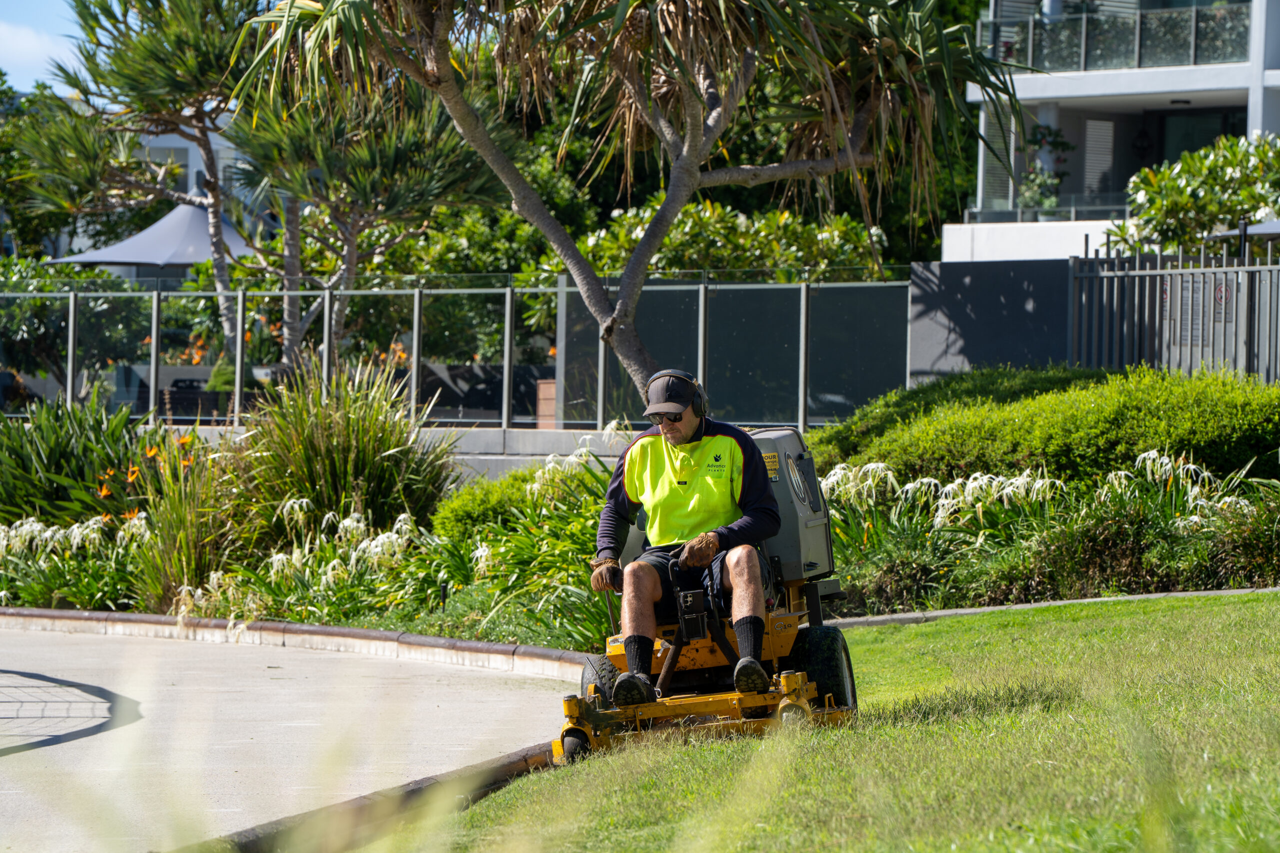 Advance Landscapes team member ride-on mowing at Allisee Residential Apartments, Hollywell