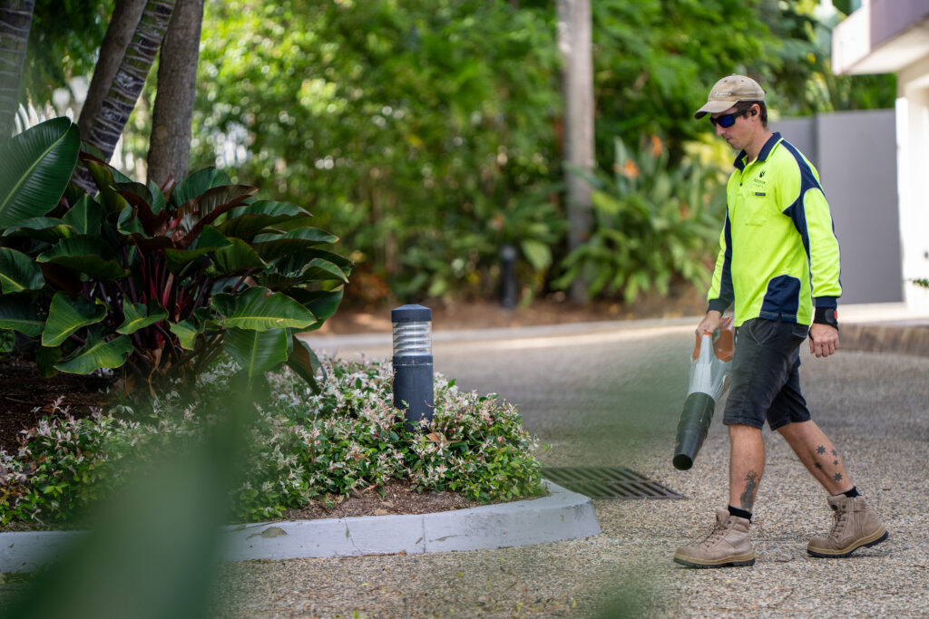 Advance Landscapes team member maintaining a tropical garden bed at Grand Mariner