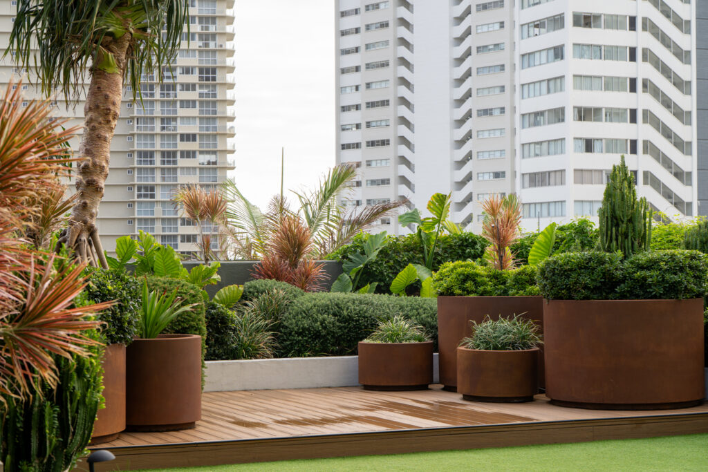 Corten planters with shrubs, succulents and palms on the Level 2 deck at QT Gold Coast, Surfers Paradise
